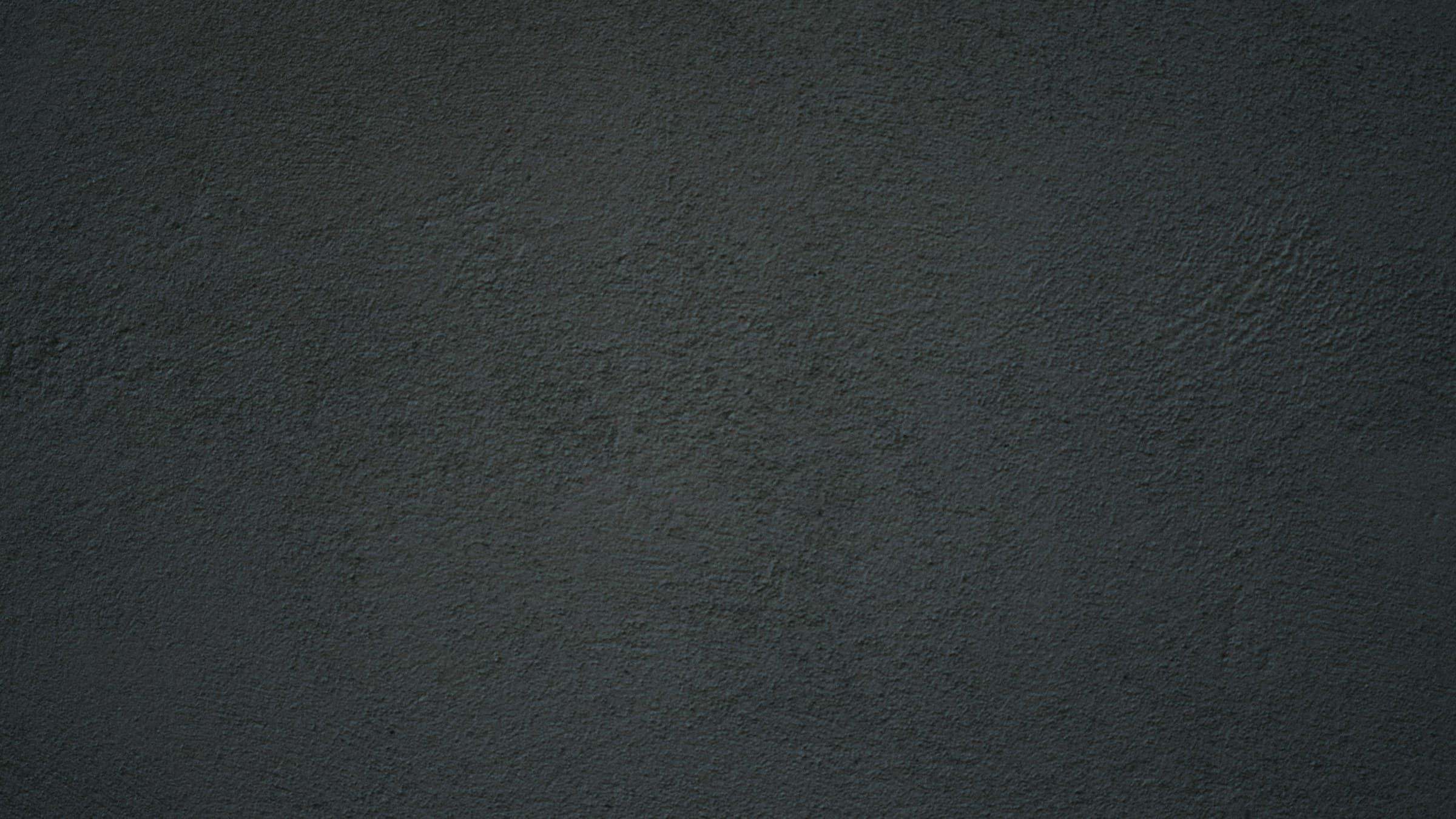 Close-up of a dark textured gallery wall